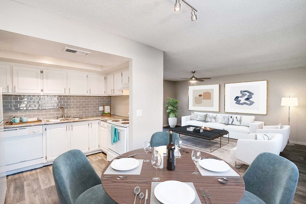 a kitchen and living room with a wooden table